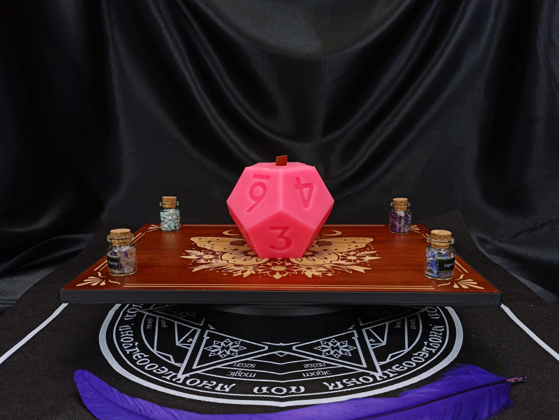 D12 ritual dice candle styled with tabletop gaming props